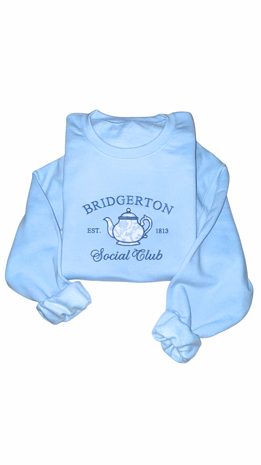 Light blue tea time Bridgerton inspired Social Club sweatshirt on white background, bookish crewneck inspired by Regency era romance readers